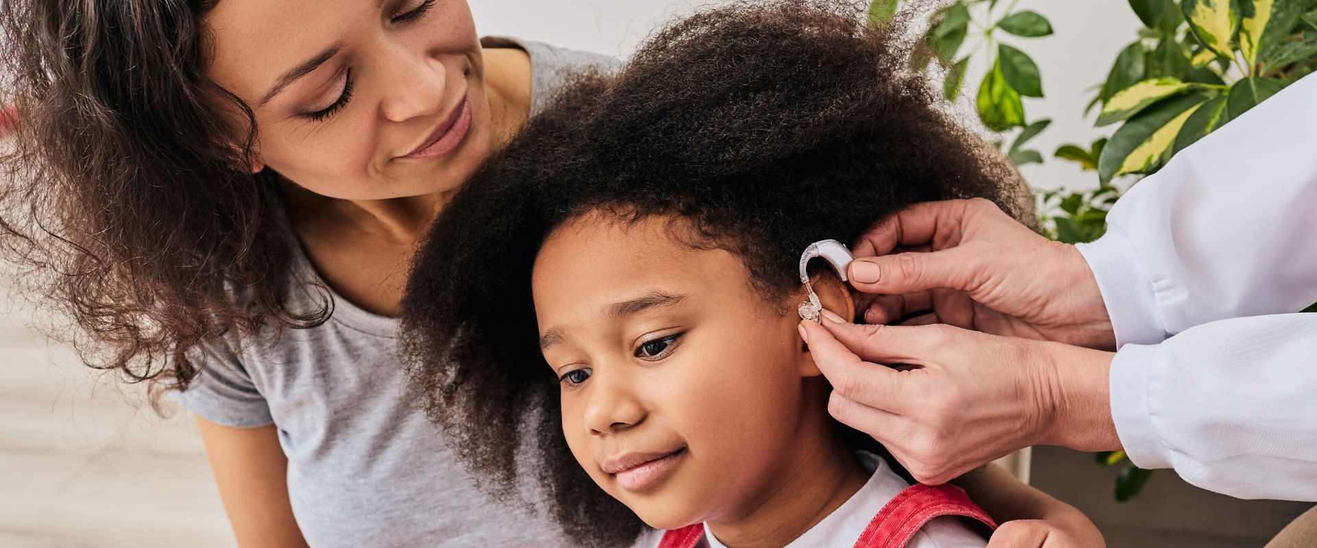Young girl getting a hearing aid