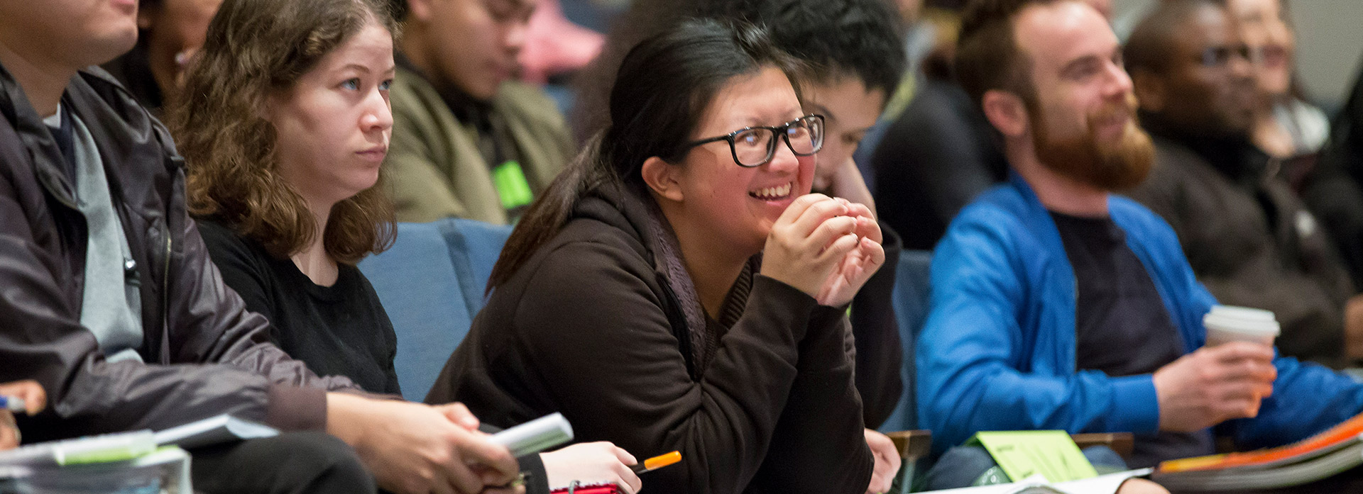 Student smiles in a lecture hall