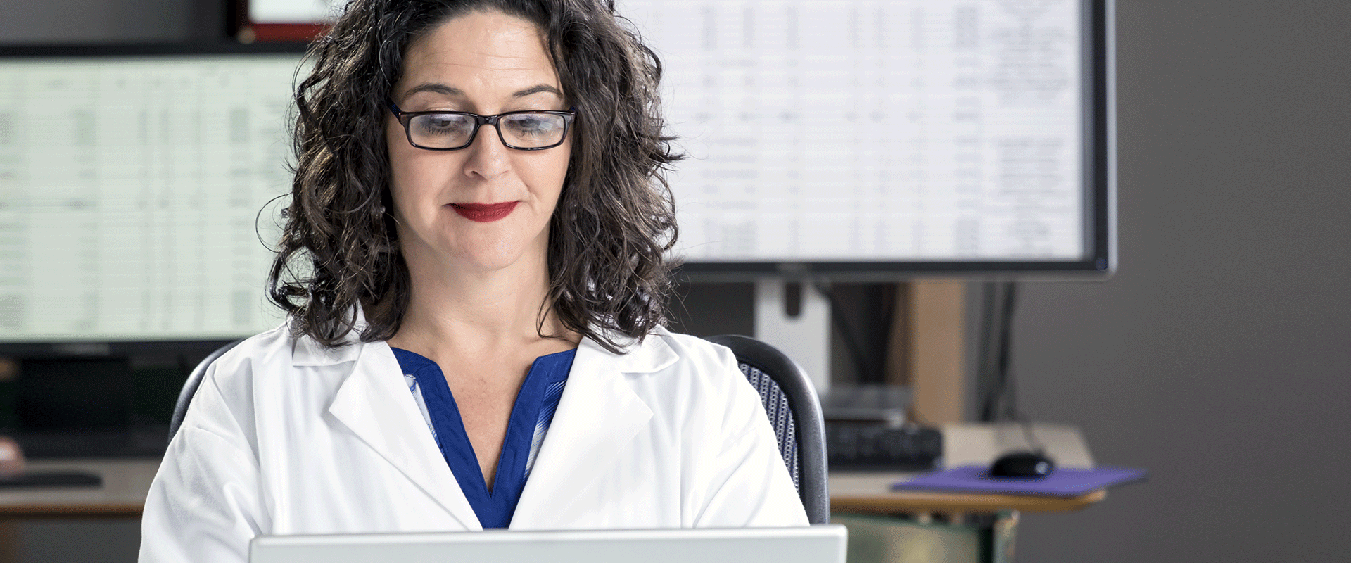 Medical billing and coding professional working on a computer