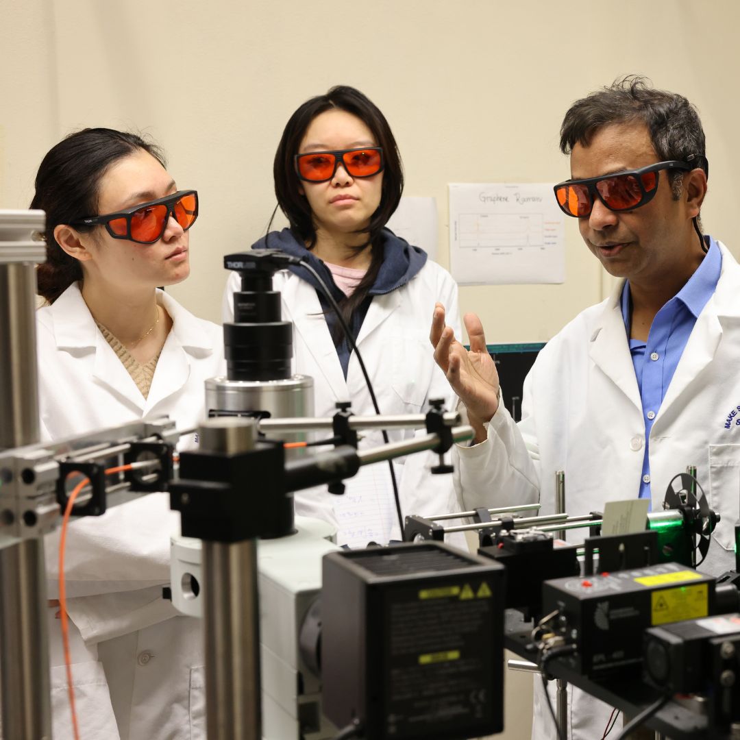 STEM students work on a machine