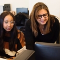 Computer science teacher working with students