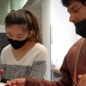 Peer mentor Judy Deng (left) and Inclusion Pilot Project student Ishaan Joshi prepare food in the Vista Room on campus