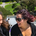 Two students with wind in their hair at the top of the steps above the Student Center