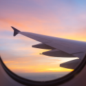 View from airplane window off the wing and a sunset sky