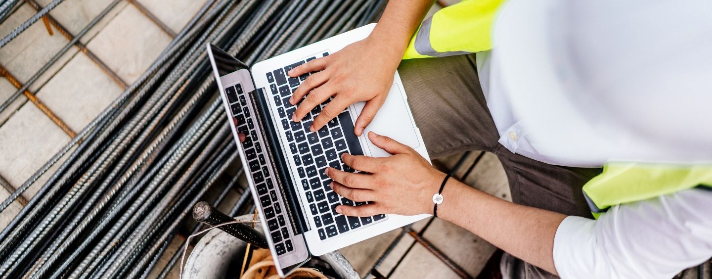 Construction worker using a laptop