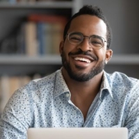 Man smiling while taking an online class