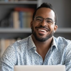 Man smiling while taking an online class