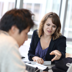 Business teacher working with a student